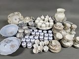 many different types of porcelain dishes and bowls on the table