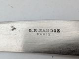 a close up of a knife on a white surface