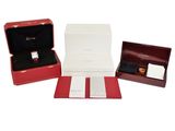 three red boxes containing a watch, a watch and a watch case