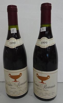 two bottles of wine sitting next to each other on a table