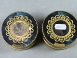 two blue and gold tins with a label on them
