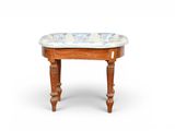 a small wooden table with a blue and white floral design on it