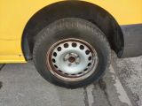 a yellow bus that is parked on the side of the road