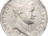 a close up of a silver coin with a man ' s face on it