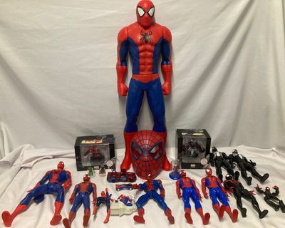 spider - man action figures and toys are displayed on a table