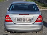 a silver car that is parked on the side of the road