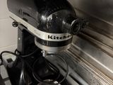 a black and silver mixer sitting on top of a stove