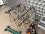 a small ladder that is sitting on the floor next to a pair of tools