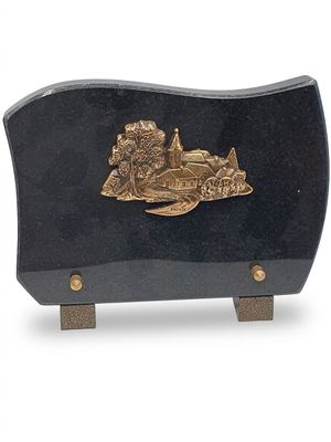 une plaque noire et dorée sur laquelle figure un bateau