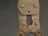 a close up of a pliers on a gray surface