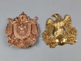 two gold colored metal badges with eagle and shield on them