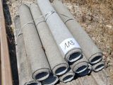 a pile of pipes sitting on the ground next to a pile of wood