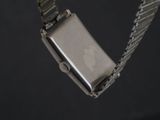 a watch that is attached to a chain on a black background