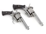 two revolvers are shown on a white surface