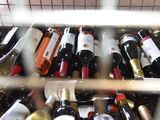 many bottles of wine that are sitting in a rack