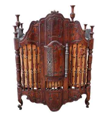an image of a wooden crib with carvings on it
