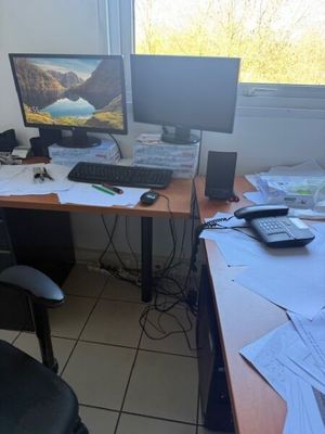 a desk with a computer and a monitor on it