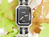 a black and silver watch with a chain around it