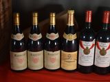 several bottles of wine are lined up on a shelf