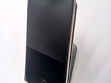a cell phone that is sitting on top of a stand