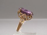 an amethorate ring with a gold band and a purple amethorate stone