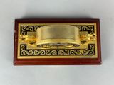 an image of a brass plate mounted to the side of a wooden plaque