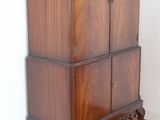 a wooden cabinet that is sitting on a hard wood floor