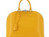 a yellow handbag on a white background
