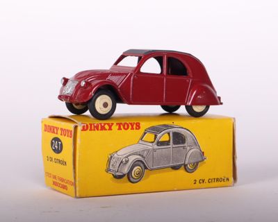 a red toy car sitting on top of a yellow box