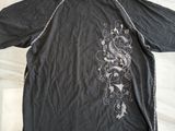 shirt on the table is black and white with a dragon on it