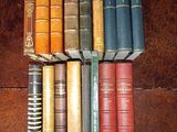 a lot of books that are stacked on top of each other
