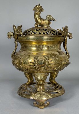 an antique brass urn with a bird on the top and a bird on the bottom