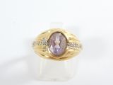 an image of a gold ring with a purple stone surrounded by diamonds
