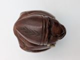 a brown leather baseball glove on a white surface