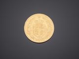 a close up of a gold coin on a black background