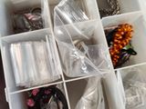 a plastic container with many different types of jewelry in it