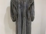 the fur coat is on display in the corner of the room
