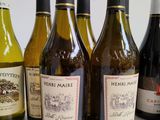 several bottles of wine are lined up on a table