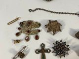 a lot of jewelry on a table with a coin