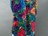 a mannequin mannequin wearing a colorful floral print dress