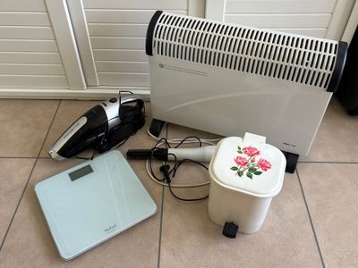 a picture of a room with a heater, a scale, and a hair dryer