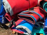a pile of luggage sitting on the ground next to a car