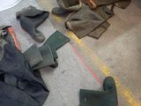 many pairs of boots and boots on the floor