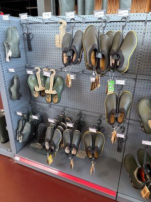 many pairs of shoes that are on display in a store