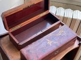 a wooden box sitting on top of a small table