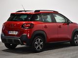 the rear view of a red citrole parked in a white room