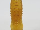 an image of a yellow glass vase on a white surface