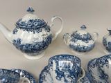 a blue and white tea set on a table
