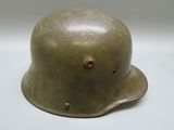 a close up of a military helmet on a white surface