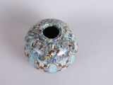 a small vase with a blue and white design on it